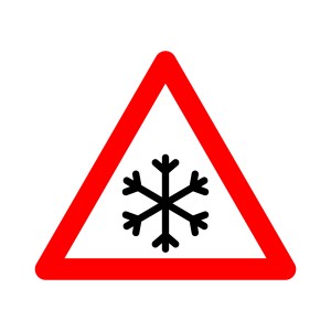 Snowfall sign. Snowfall warning sign. Red triangle sign with a snowflake icon inside. Caution, snowfall, slippery road. Road sign snowfall. Snow and ice sign
